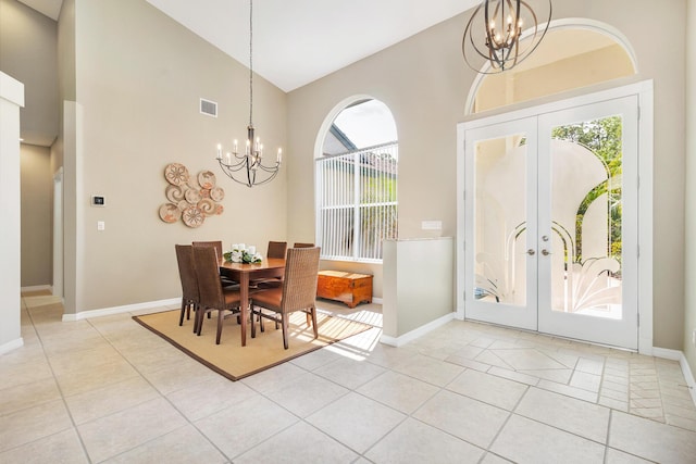 dining area with light tile patterned floors, visible vents, french doors, and a notable chandelier