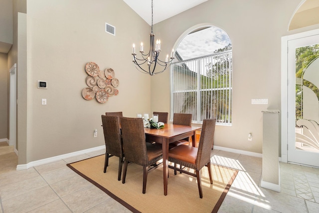 dining room featuring an inviting chandelier, a wealth of natural light, light tile patterned flooring, and visible vents