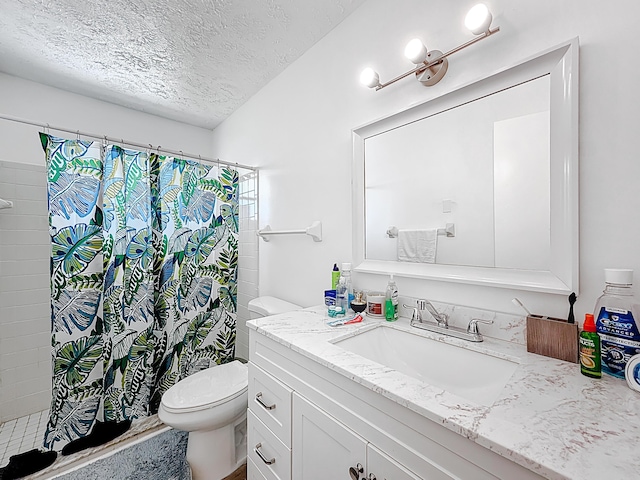 full bath with toilet, vanity, curtained shower, and a textured ceiling