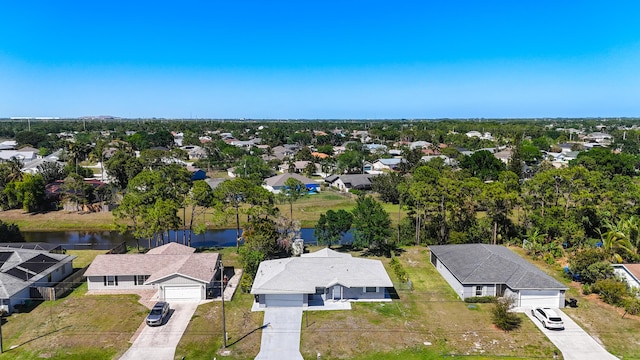 drone / aerial view with a residential view and a water view