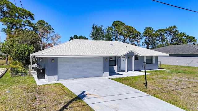 ranch-style home with driveway, a garage, a front lawn, stucco siding, and a shingled roof