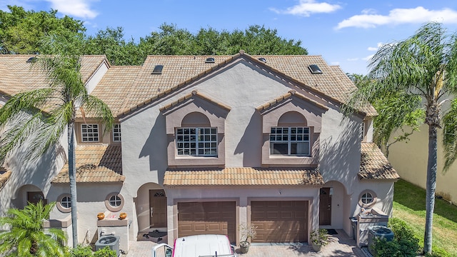 9448 Boca River Cir, Boca Raton, FL 33434 - mediterranean / spanish house with a tile roof, stucco siding, an attached garage, and driveway