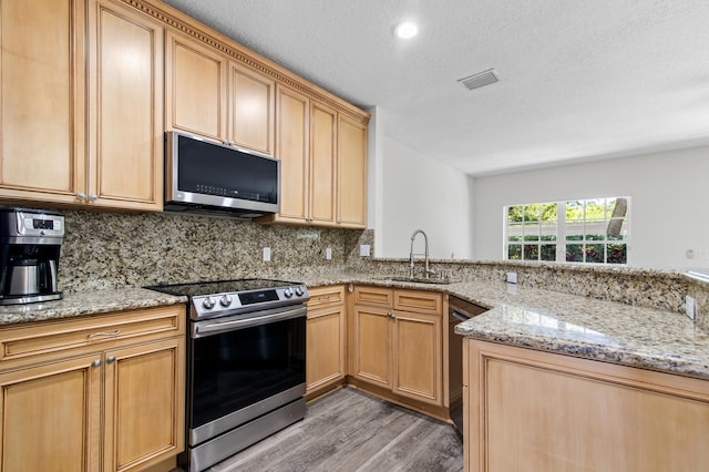 9448 Boca River Cir, Boca Raton, FL 33434 - kitchen with visible vents, stainless steel appliances, tasteful backsplash, a sink, and light stone counters