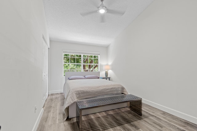 9448 Boca River Cir, Boca Raton, FL 33434 - bedroom with baseboards, a textured ceiling, wood finished floors, and ceiling fan