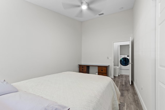 9448 Boca River Cir, Boca Raton, FL 33434 - bedroom with wood finished floors, washer / dryer, baseboards, visible vents, and ceiling fan