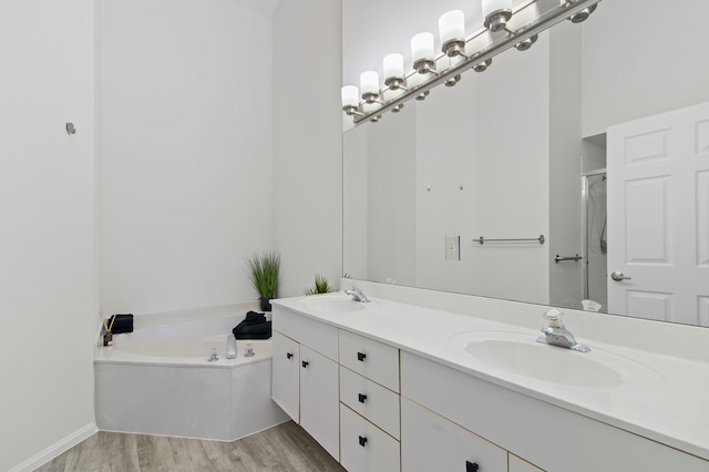 9448 Boca River Cir, Boca Raton, FL 33434 - full bath featuring double vanity, a sink, a garden tub, and wood finished floors