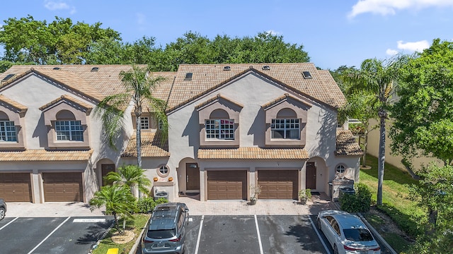 9448 Boca River Cir, Boca Raton, FL 33434 - mediterranean / spanish home with a tiled roof, stucco siding, and a garage