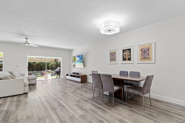 9448 Boca River Cir, Boca Raton, FL 33434 - dining room featuring baseboards, a textured ceiling, wood finished floors, and a ceiling fan
