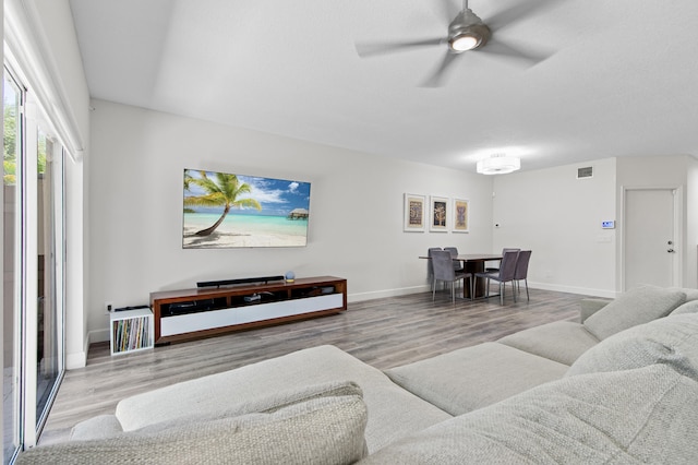 9448 Boca River Cir, Boca Raton, FL 33434 - living room featuring baseboards, visible vents, wood finished floors, and ceiling fan
