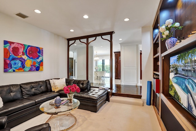 living room with carpet floors, a notable chandelier, visible vents, and recessed lighting
