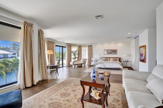 living room with visible vents, recessed lighting, and wood finished floors