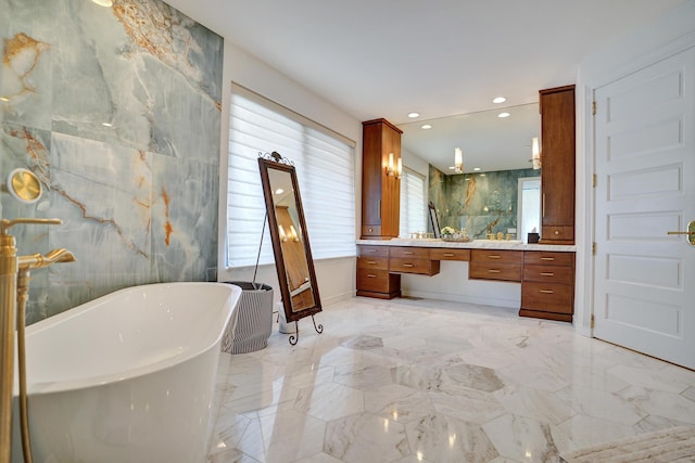 bathroom featuring recessed lighting, vanity, marble finish floor, and a soaking tub