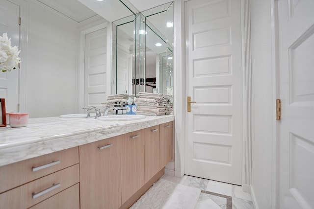 bathroom with crown molding and vanity