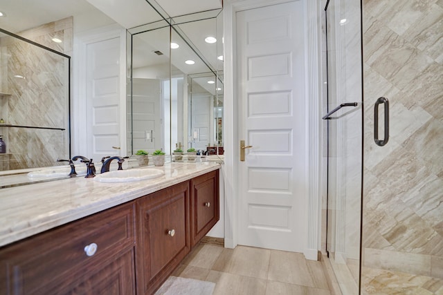 bathroom with tile patterned floors, vanity, and a stall shower