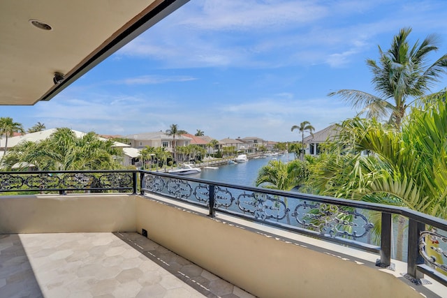 balcony featuring a water view and a residential view