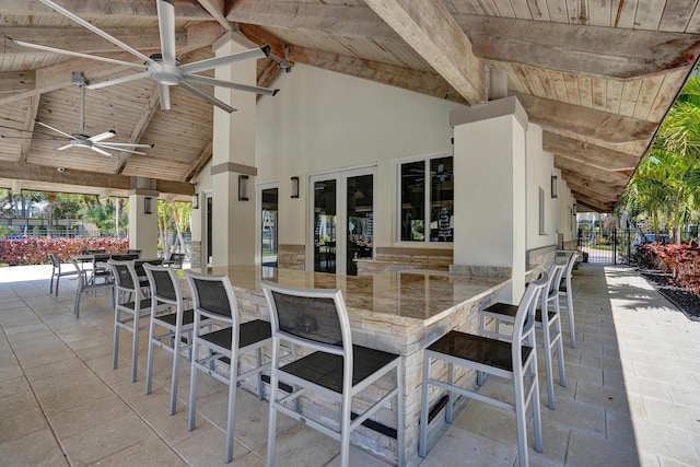 view of patio with fence, a ceiling fan, and outdoor dry bar