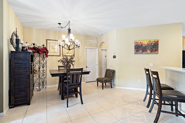 9686 SW Glenbrook Dr, Port Saint Lucie, FL 34987 - dining space featuring a notable chandelier, light tile patterned floors, baseboards, visible vents, and arched walkways