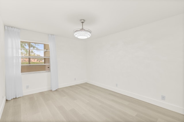 361 Normandy H, Delray Beach, FL 33484 - spare room with light wood-style floors and baseboards