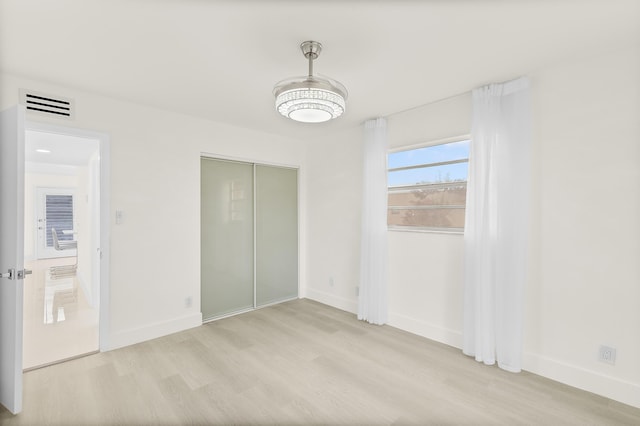 361 Normandy H, Delray Beach, FL 33484 - unfurnished bedroom with light wood-style floors, baseboards, and a closet