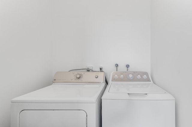 361 Normandy H, Delray Beach, FL 33484 - clothes washing area featuring washer and dryer