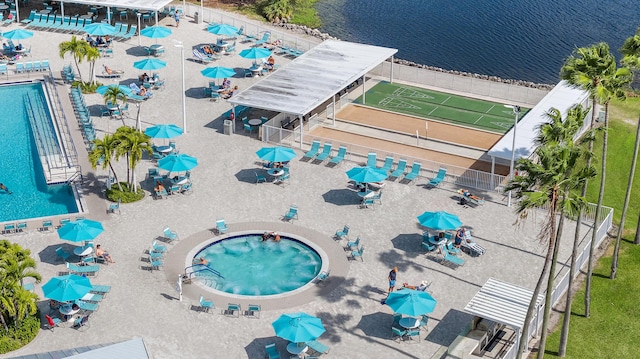 361 Normandy H, Delray Beach, FL 33484 - drone / aerial view of a pool area and a nearby body of water
