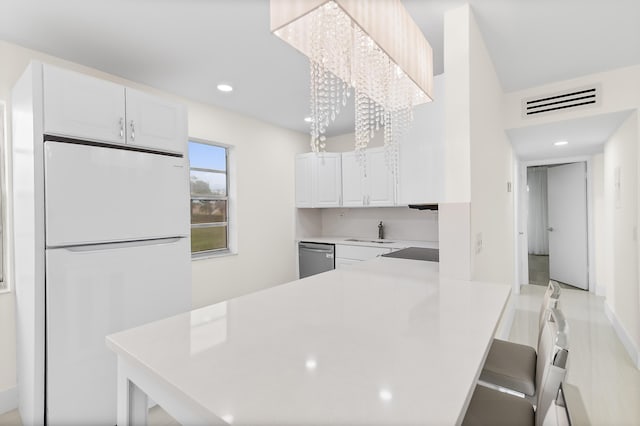 361 Normandy H, Delray Beach, FL 33484 - kitchen featuring freestanding refrigerator, dishwasher, white cabinets, light countertops, and a sink