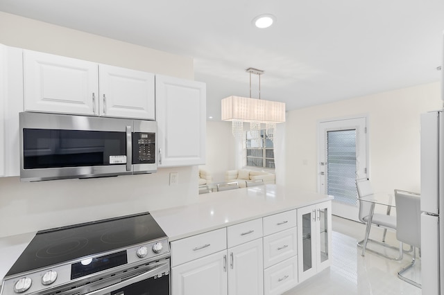 361 Normandy H, Delray Beach, FL 33484 - kitchen with appliances with stainless steel finishes, white cabinets, a peninsula, light countertops, and recessed lighting