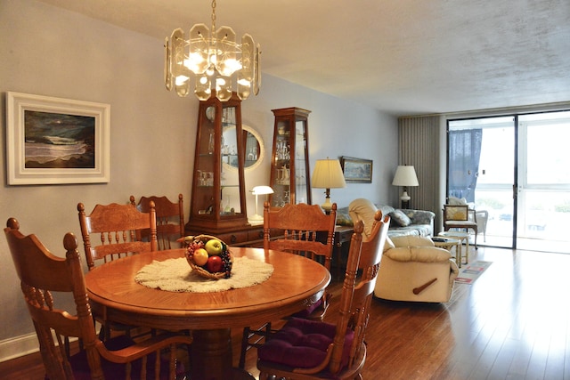 2841 Somerset Dr Unit 217, Lauderdale Lakes, FL 33311 - dining room with dark wood-style floors, a chandelier, expansive windows, and baseboards