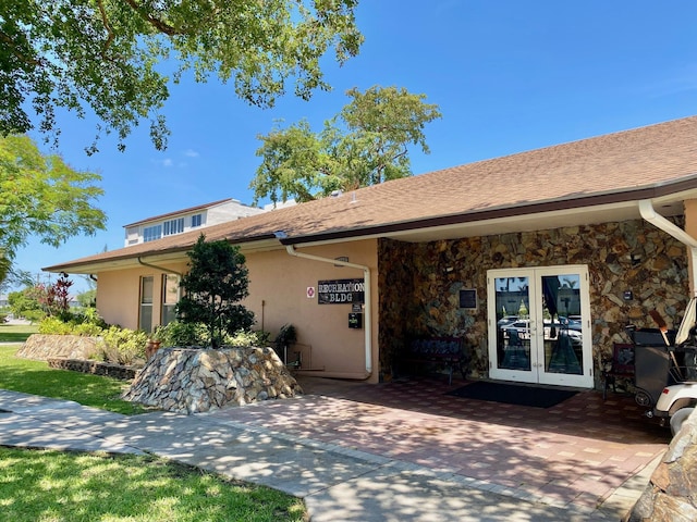 2841 Somerset Dr Unit 217, Lauderdale Lakes, FL 33311 - view of front facade featuring french doors, stucco siding, and stone siding