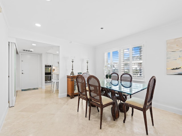 dining area featuring visible vents, crown molding, and baseboards