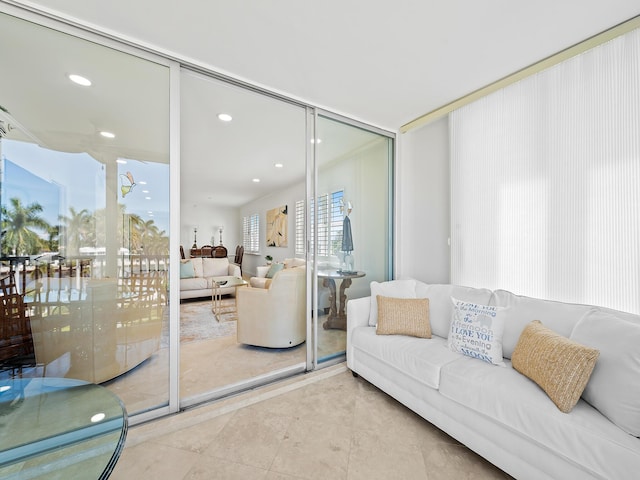 tiled living area featuring recessed lighting