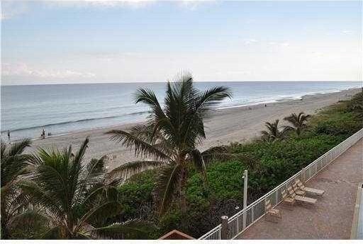 view of water feature with a beach view and fence