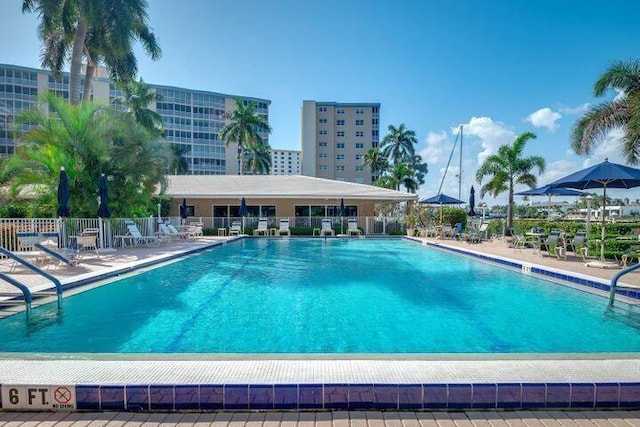pool with fence and a patio area