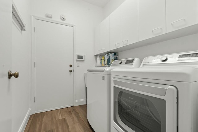 2437 NW 64th St, Boca Raton, FL 33496 - washroom with independent washer and dryer, wood finished floors, and cabinet space