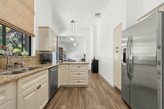 2437 NW 64th St, Boca Raton, FL 33496 - kitchen with light wood-style flooring, crown molding, stainless steel appliances, a sink, and backsplash