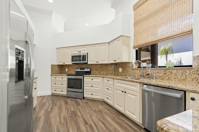 2437 NW 64th St, Boca Raton, FL 33496 - kitchen with decorative backsplash, crown molding, wood finished floors, stainless steel appliances, and a sink