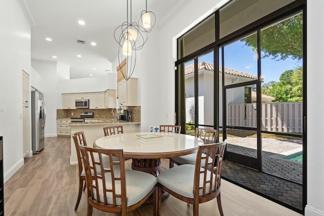 2437 NW 64th St, Boca Raton, FL 33496 - dining space featuring ornamental molding, baseboards, light wood-style floors, and visible vents