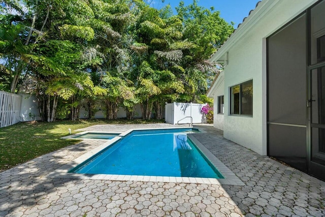 2437 NW 64th St, Boca Raton, FL 33496 - view of swimming pool featuring a fenced backyard, a lawn, a pool with connected hot tub, and a patio area