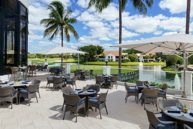 2437 NW 64th St, Boca Raton, FL 33496 - view of patio featuring outdoor dining area and a water view