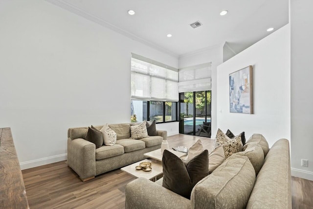 2437 NW 64th St, Boca Raton, FL 33496 - living area with baseboards, visible vents, wood finished floors, and ornamental molding
