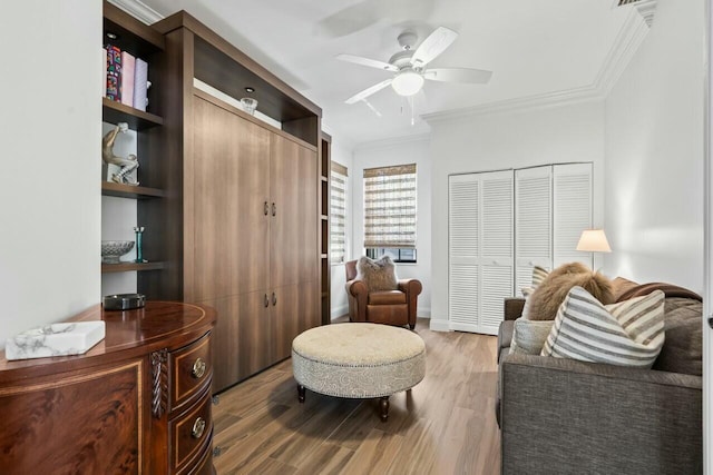 2437 NW 64th St, Boca Raton, FL 33496 - living area with baseboards, crown molding, wood finished floors, and a ceiling fan