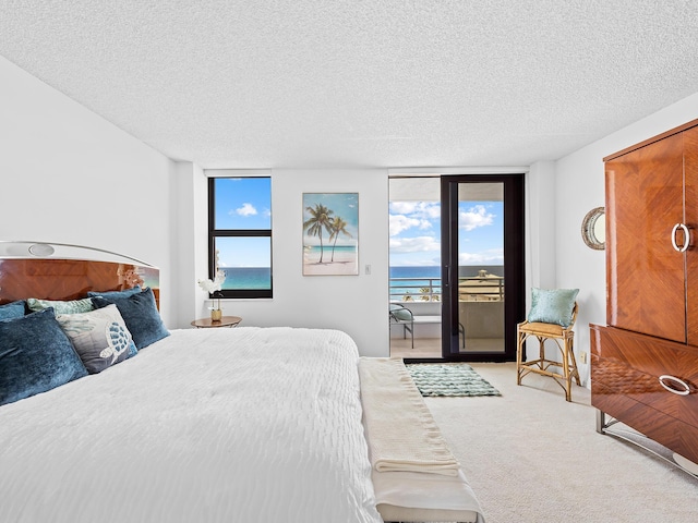 3450 S Ocean Blvd Unit 906, Highland Beach, FL 33487 - carpeted bedroom with access to exterior, a textured ceiling, and multiple windows