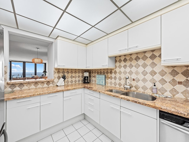 3450 S Ocean Blvd Unit 906, Highland Beach, FL 33487 - kitchen with white dishwasher, a sink, white cabinetry, backsplash, and light stone countertops