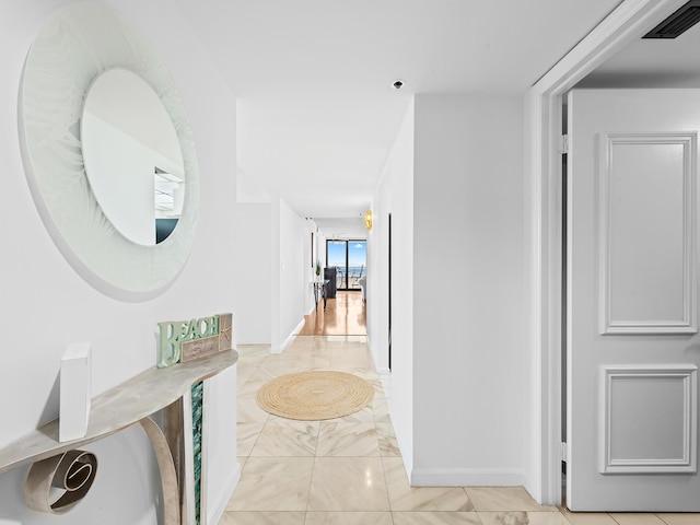 3450 S Ocean Blvd Unit 906, Highland Beach, FL 33487 - hall featuring light marble finish floors and baseboards
