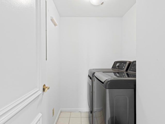 3450 S Ocean Blvd Unit 906, Highland Beach, FL 33487 - laundry area featuring washer and clothes dryer, light tile patterned floors, and baseboards