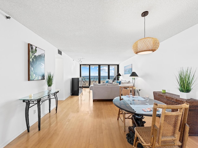 3450 S Ocean Blvd Unit 906, Highland Beach, FL 33487 - dining area with a textured ceiling and light wood finished floors