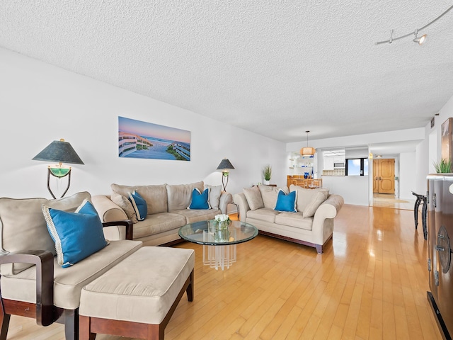 3450 S Ocean Blvd Unit 906, Highland Beach, FL 33487 - living area with a textured ceiling and light wood-style floors