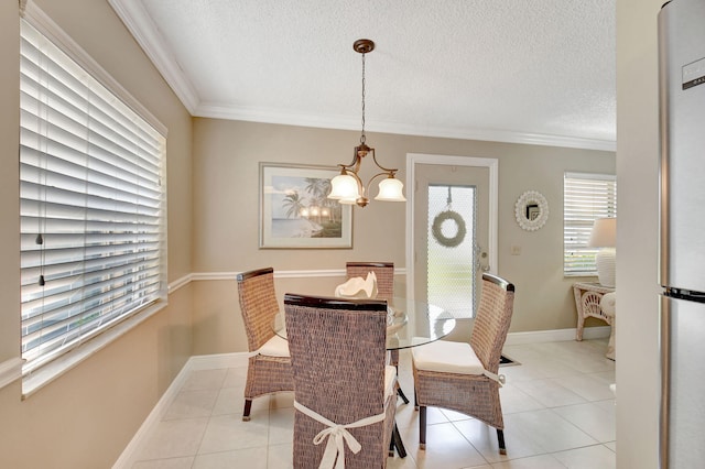 dining space with light tile patterned flooring, a textured ceiling, a chandelier, and crown molding
