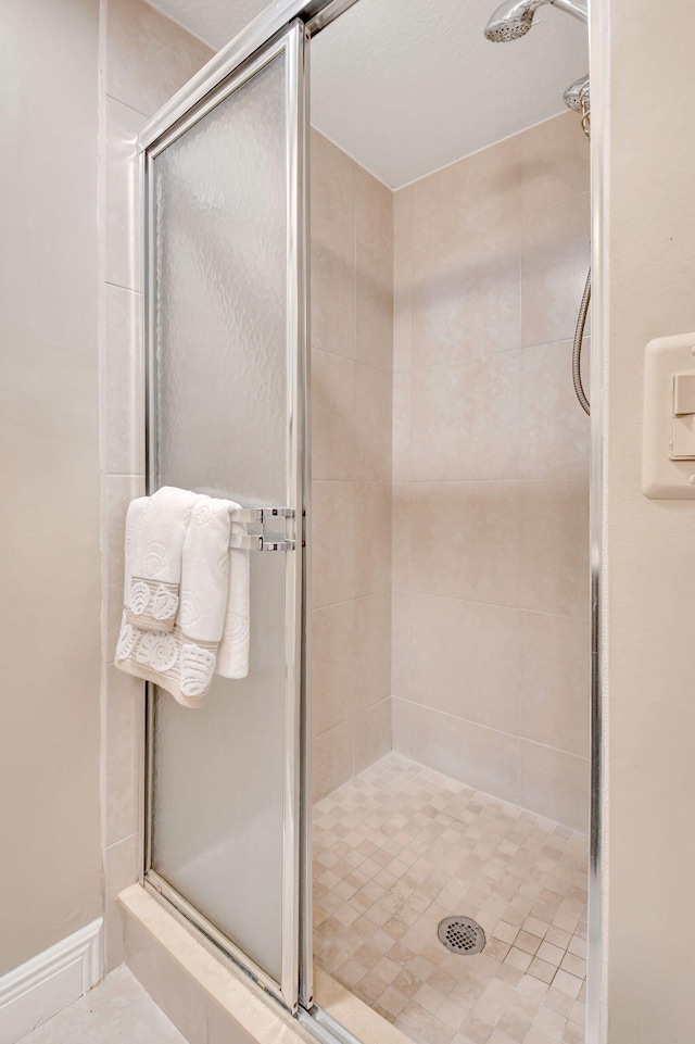 full bath featuring a shower stall
