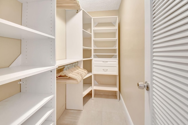 spacious closet with light tile patterned flooring